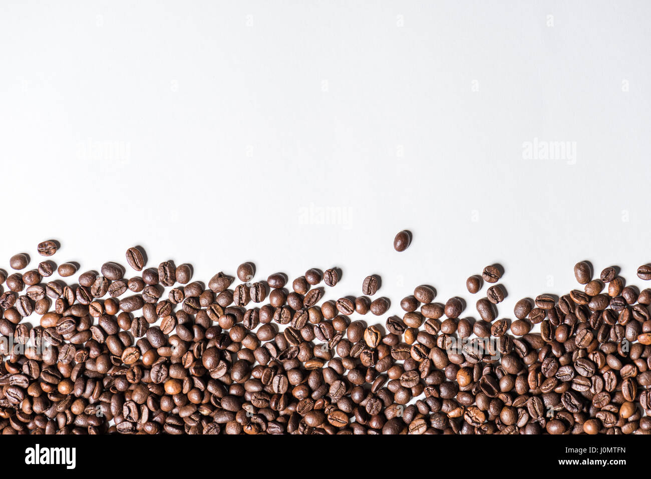 Top view of roasted coffee beans on white background Stock Photo - Alamy