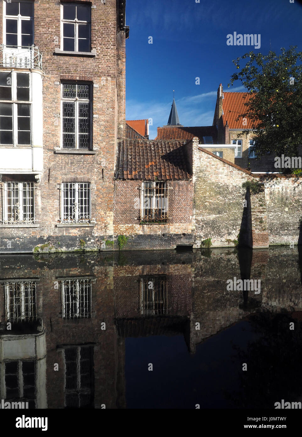 Bruges Belgium historic houses with tile roof on canal Europe Stock Photo