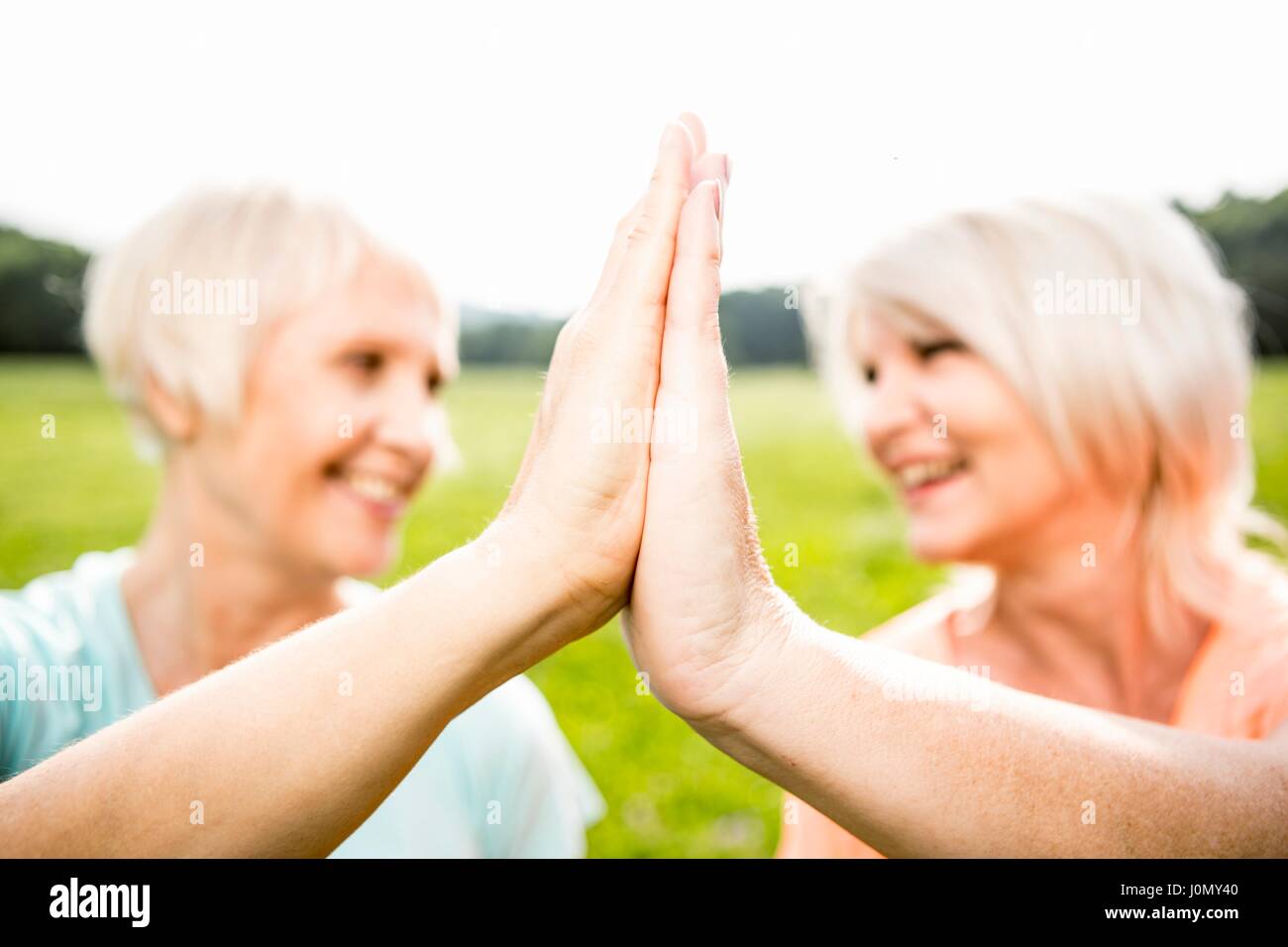 Two women with hands touching. Stock Photo