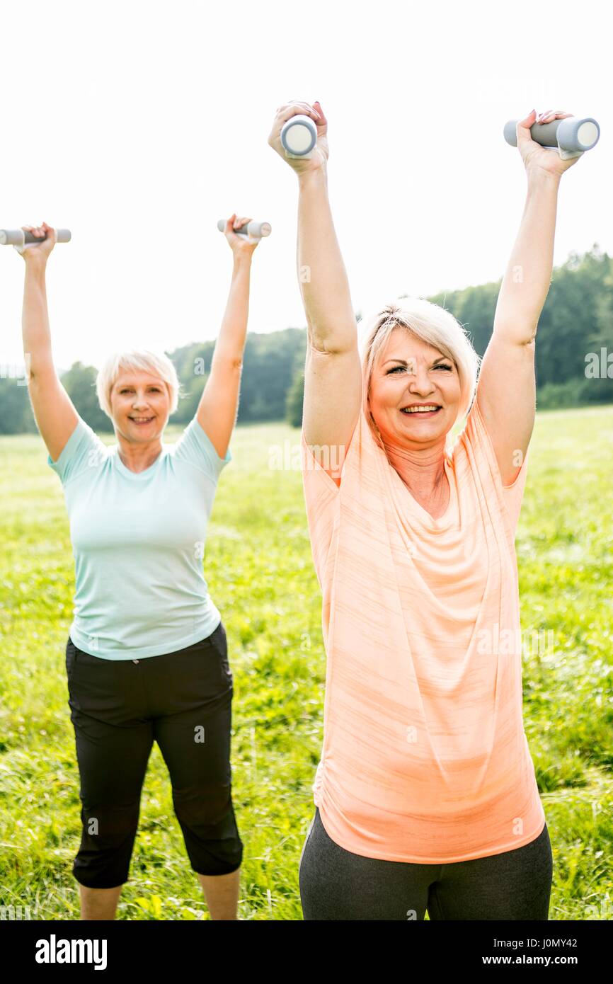 Two women exercising with hand weights. Stock Photo