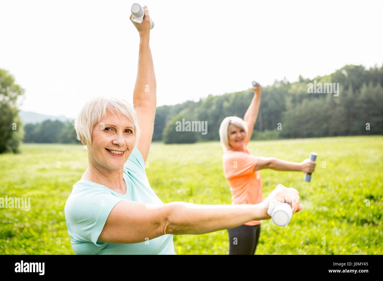 Two women exercising with hand weights. Stock Photo