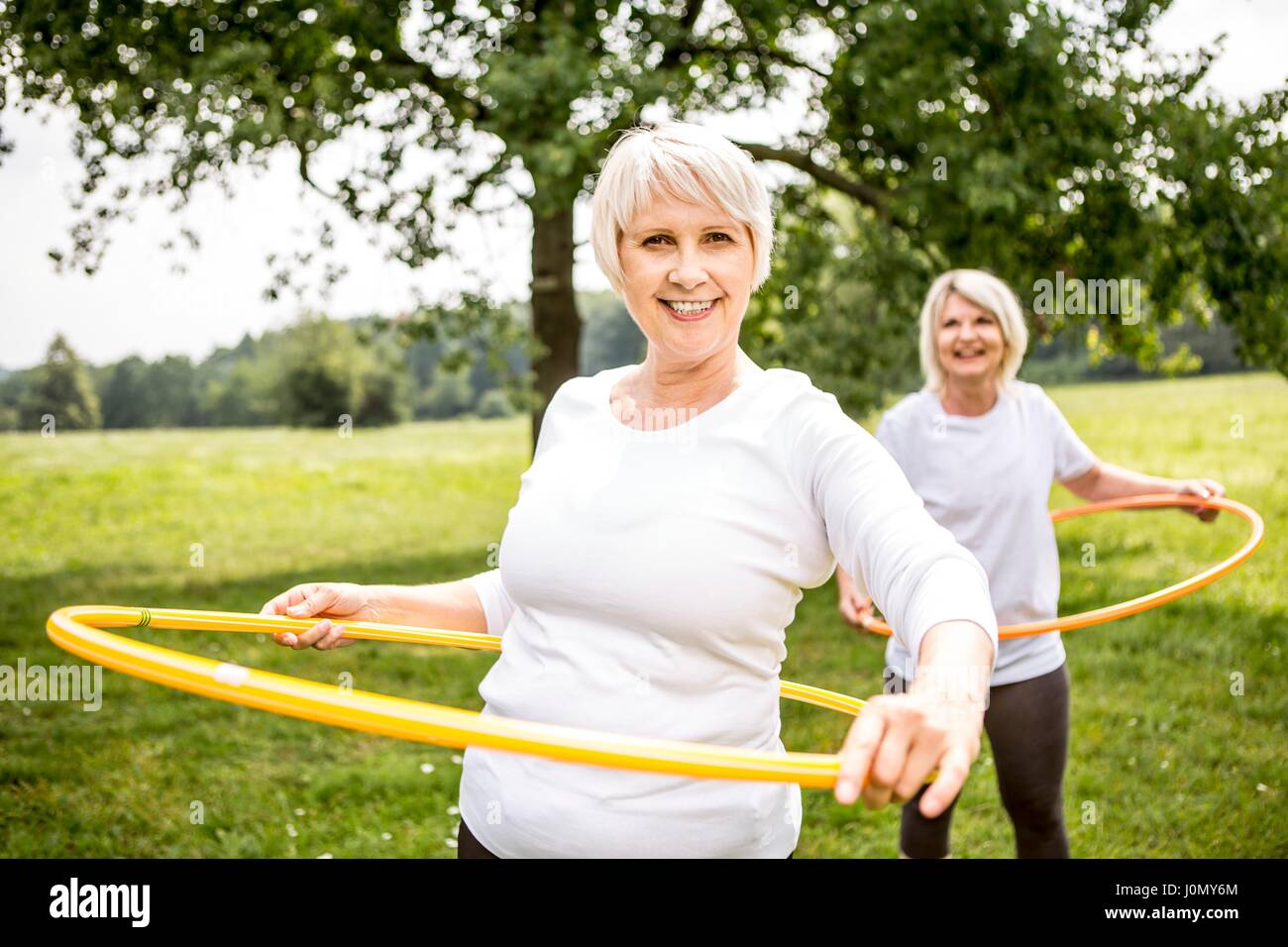 Two women with plastic hoops. Stock Photo