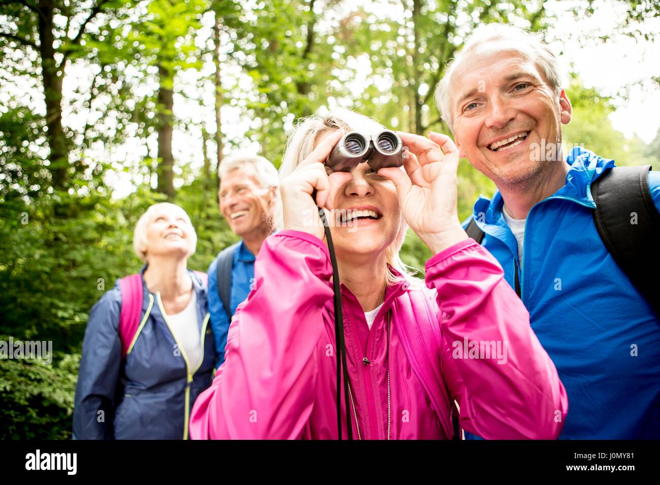 Senior woman looking through binoculars. Stock Photo