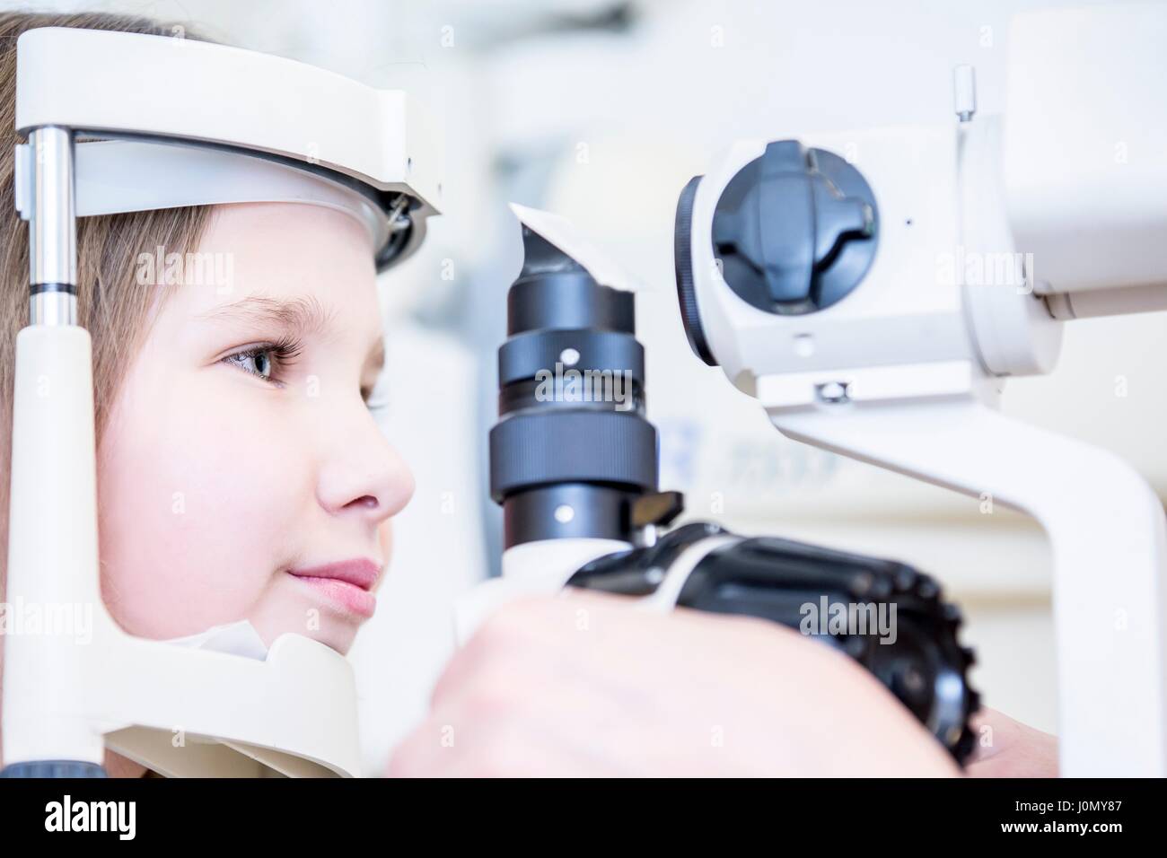 Girl patient having eye examination in optometrist's shop, close-up. Stock Photo