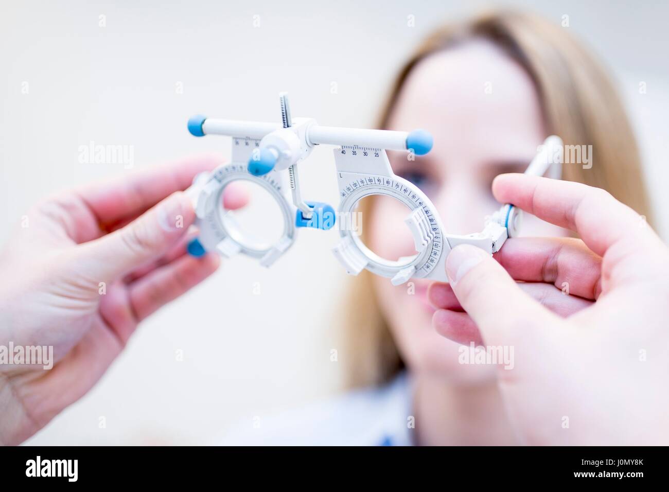 Young woman having eye exam performed by optometrist. Stock Photo