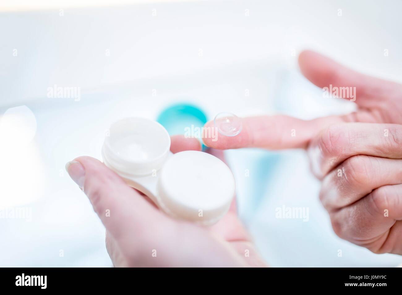 Close-up of person holding contact lens case. Stock Photo