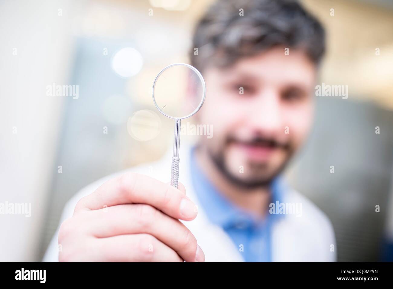 Optometrist holding magnifying glass. Stock Photo