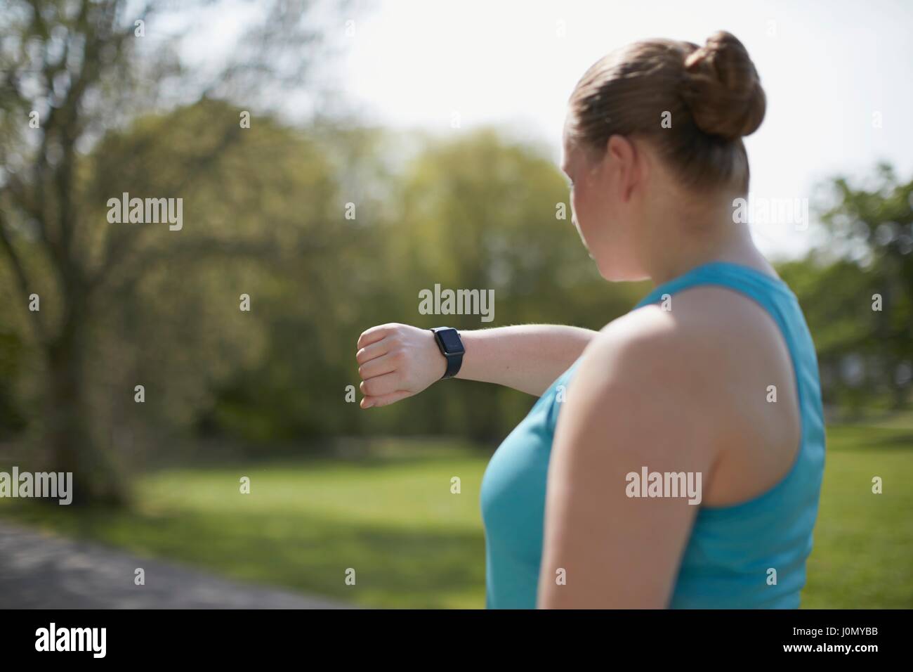 Young woman checking sports watch. Stock Photo