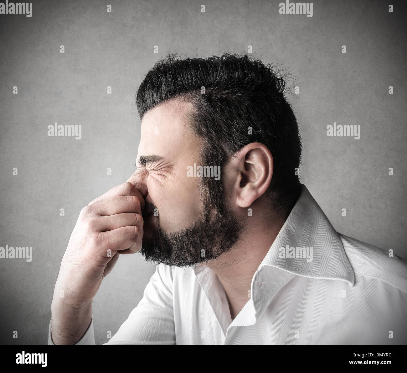 Man smelling something bad Stock Photo Alamy