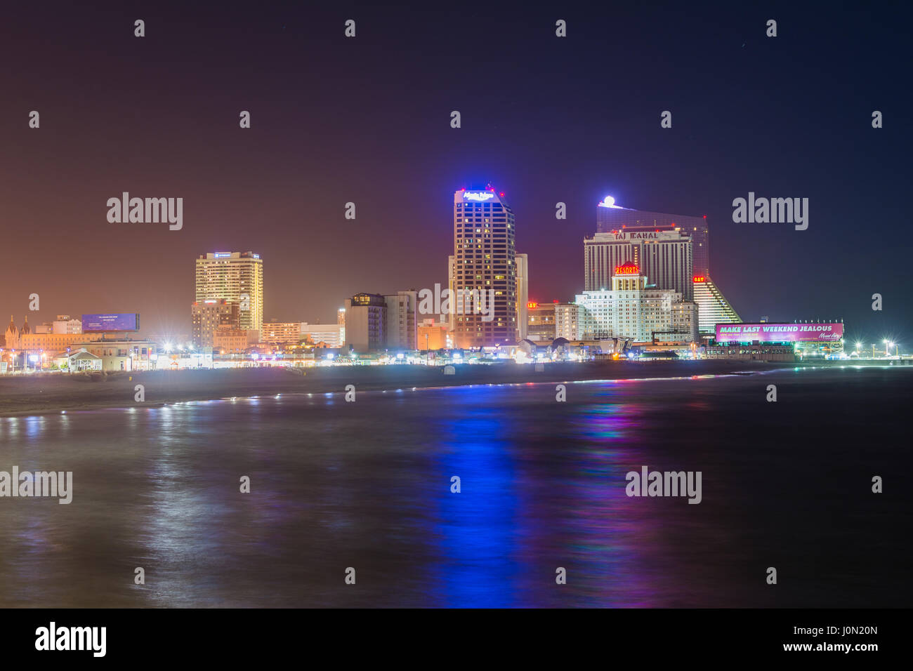 The skyline and Atlantic Ocean at night, in Atlantic City, New Jersey ...