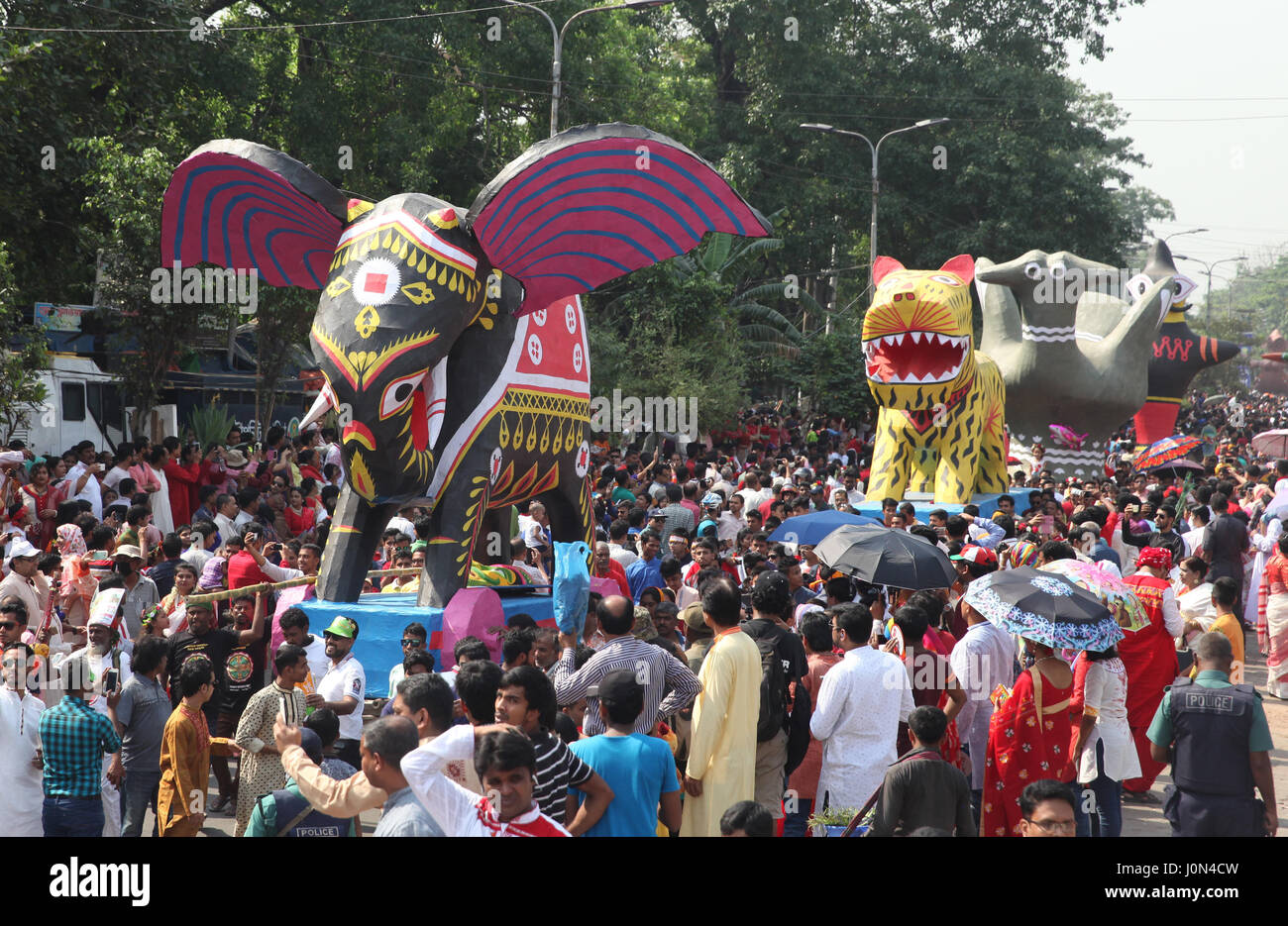 Dhaka, Bangladesh. 14th Apr, 2017. People of all walks of life including students and cultural activists attend the Mangal Shobhajatra rally held to celebrate Pahela Baishakh, the first day of the first month of the Bangla calendar year 1424, in Dhaka, Bangladesh, 14 April 2017. The day is celebrated across the country while the United Nations Educational, Scientific and Cultural Organization (UNESCO) added the Mangal Shobhajatra festival on Pahela Baishakh, among other new items, to the safeguarding intangible cultural heritage list. Credit: ZUMA Press, Inc./Alamy Live News Stock Photo