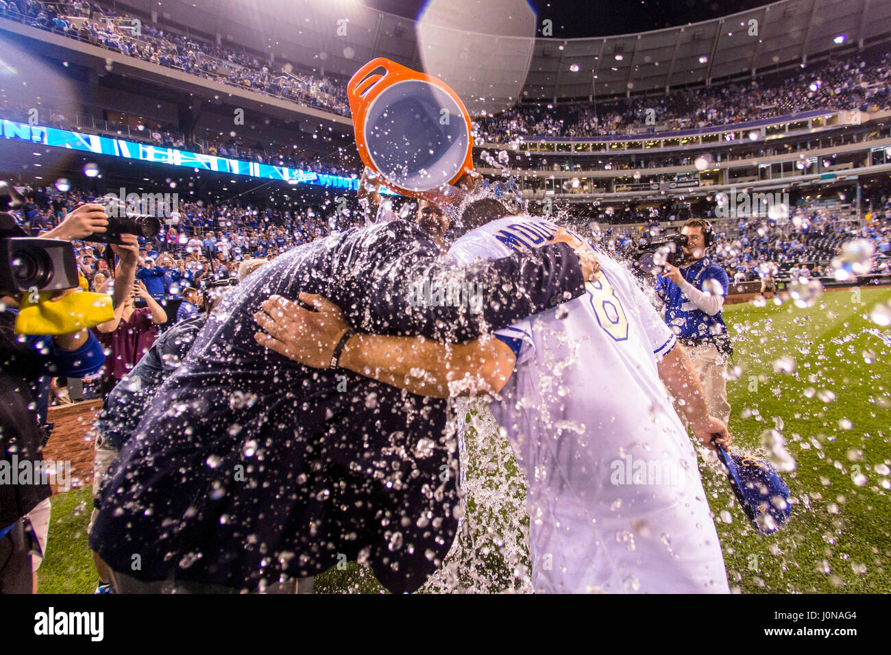 Kansas City, MO, USA. 14th Apr, 2017. Mike Moustakas #8 and announcer Joel Goldberg take a dunk of water from Salvador Perez #13 of the Kansas City Royals after the MLB game action between the Kansas City Royals and the Los Angeles Angels at Kauffman Stadium in Kansas City, MO. Kyle Rivas/CSM/Alamy Live News Stock Photo