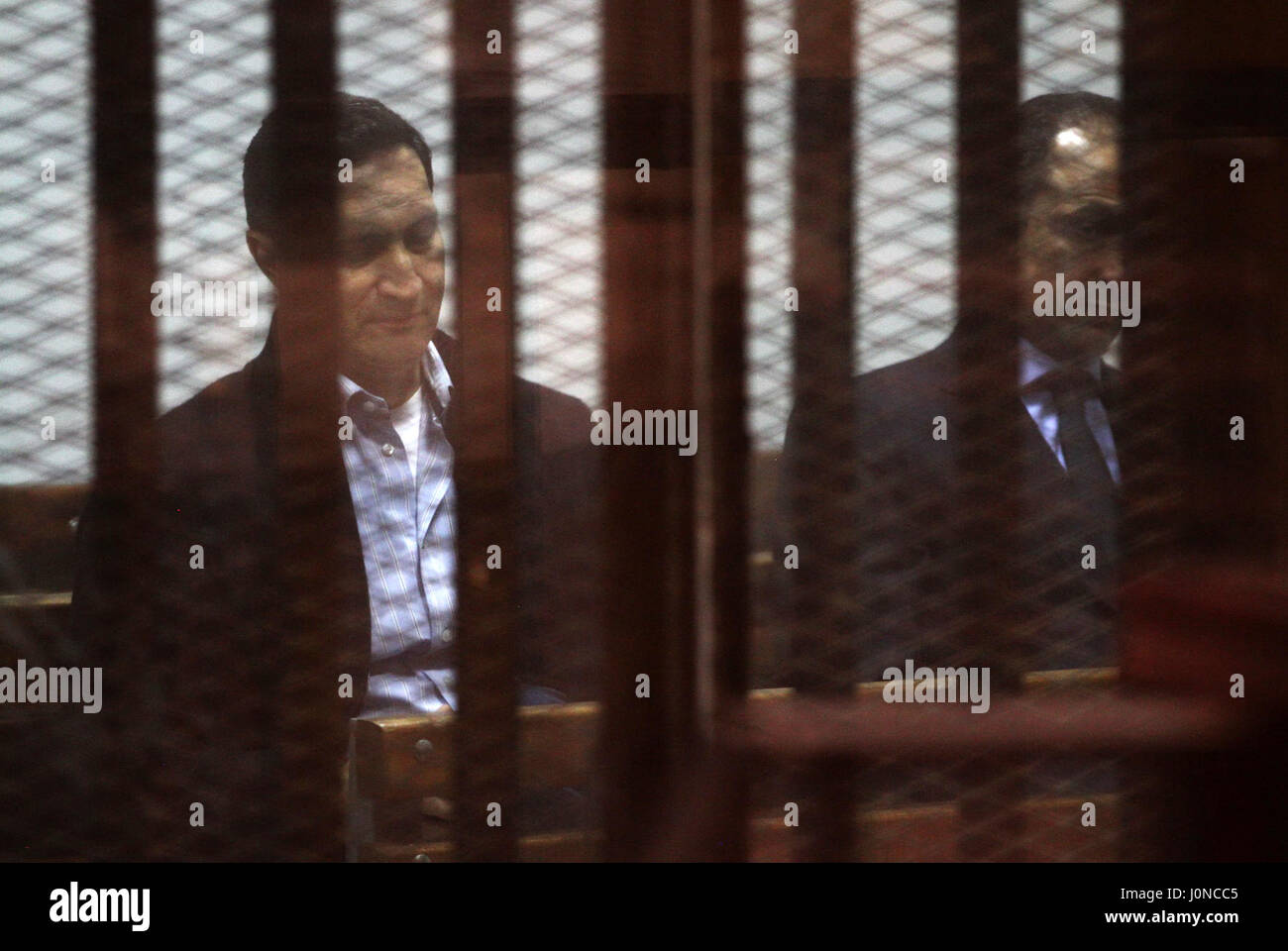 Cairo, Egypt. 15th Apr, 2017. Alaa and Gamal Mubarak, the sons of former president Hosni Mubarak sit in a courtroom cage during their trial in ''Stock Market Manipulation'' case, in Cairo. Credit: ZUMA Press, Inc./Alamy Live News Stock Photo