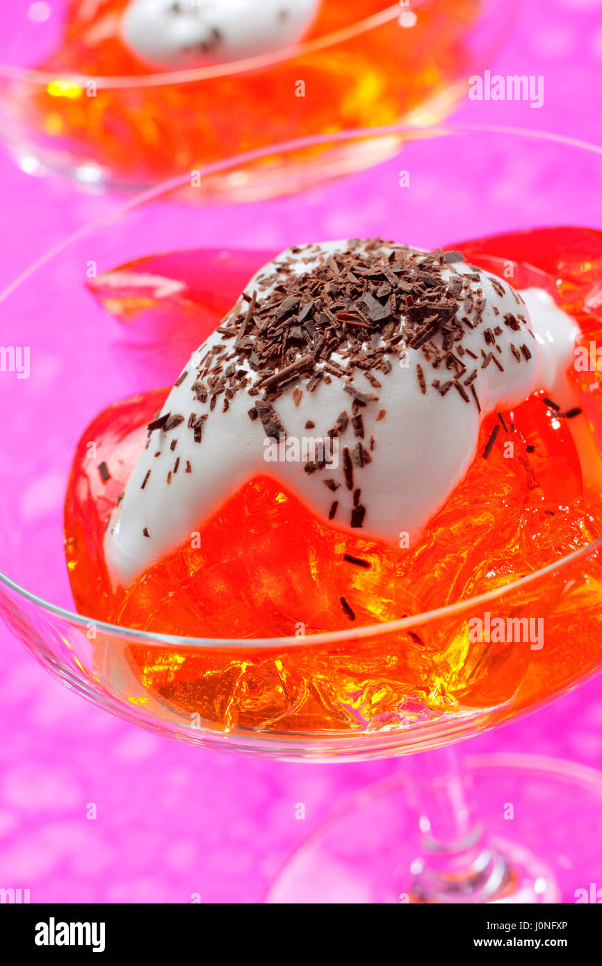 Jelly with whipped cream and chocolate garnish in a glass Stock Photo