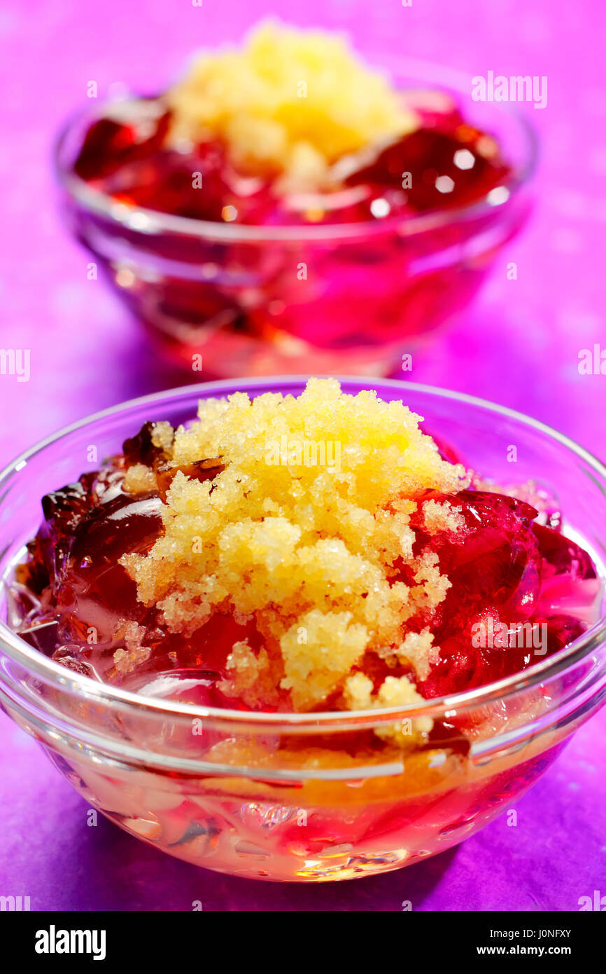 Assorted jellies in bowl with lemon sorbet. Second bowl on unfocused background. Stock Photo