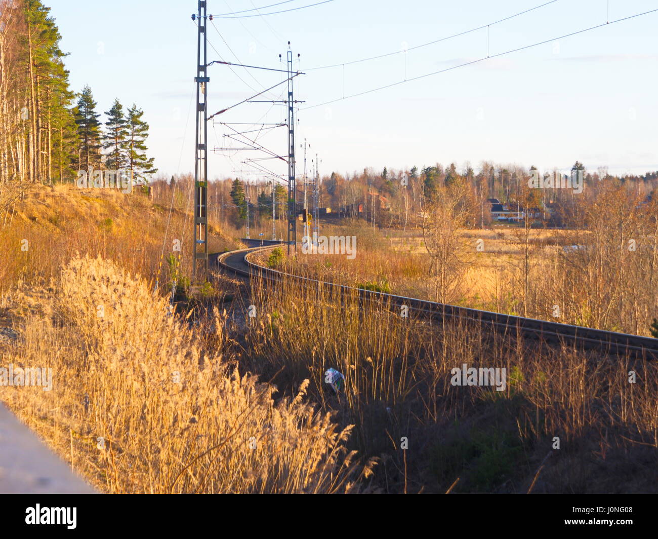urved railway with trees and blue sky Stock Photo - Alamy