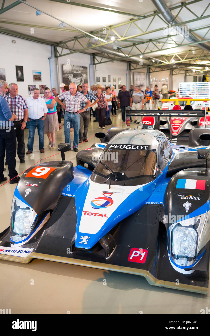 Visitors view Peugeot 908 HDI FAP 2009 diesel race car at the exhibition musee at Le Mans Racetrack, France Stock Photo