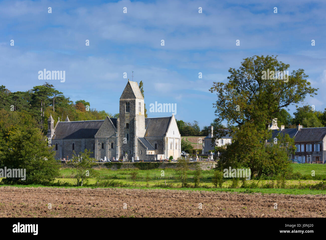 Ancient typical Norman style church and village at Vaux-sur-Aure in Normandy Stock Photo