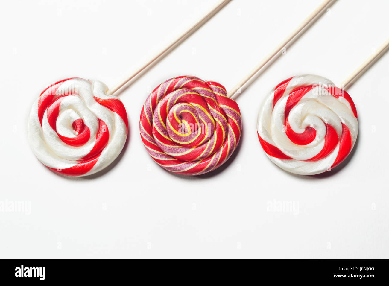 Lollipops on a stick on a white background. Flat lay. Shallow DOF Stock Photo