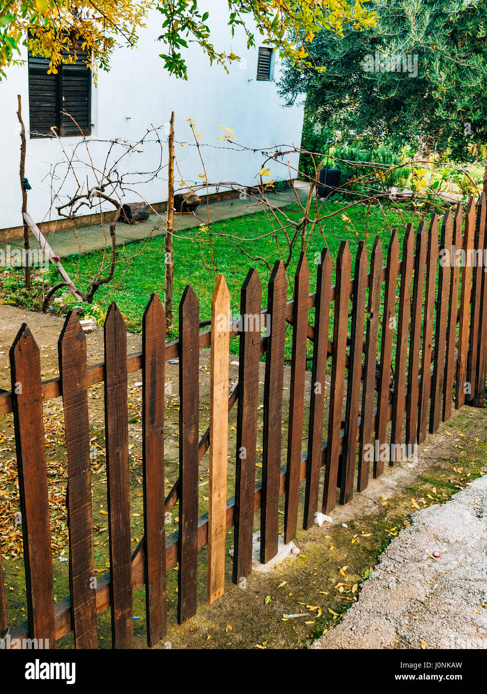 A wooden fence fence in the village near the house Stock Photo - Alamy