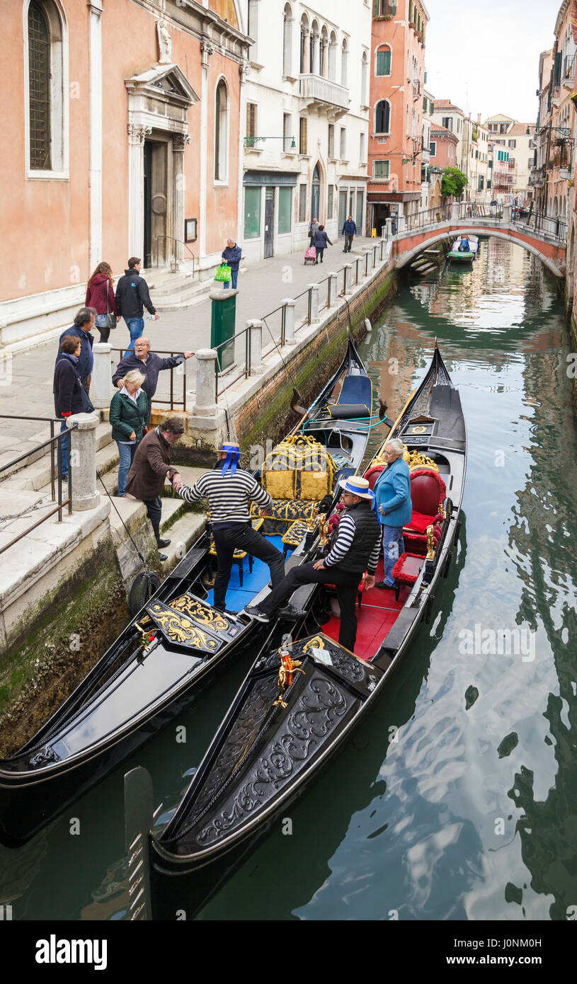 tourists boarding gondolas, Venice, Veneto, Italy Stock Photo