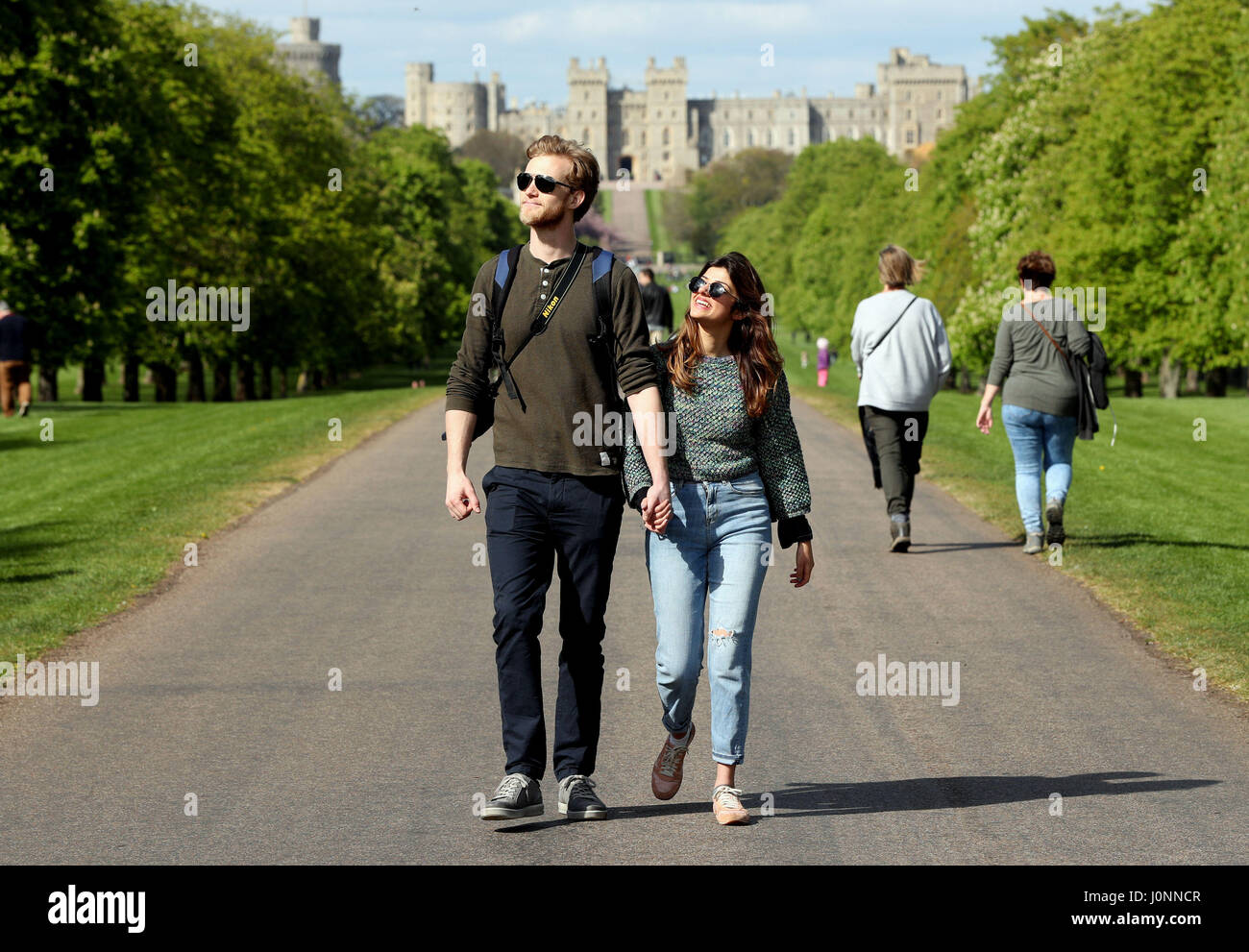 A couple stroll along the Long Walk in Windsor Great Park , Berkshire, over the Easter break. Stock Photo