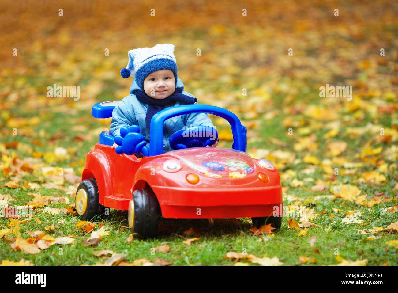 kid in toy car