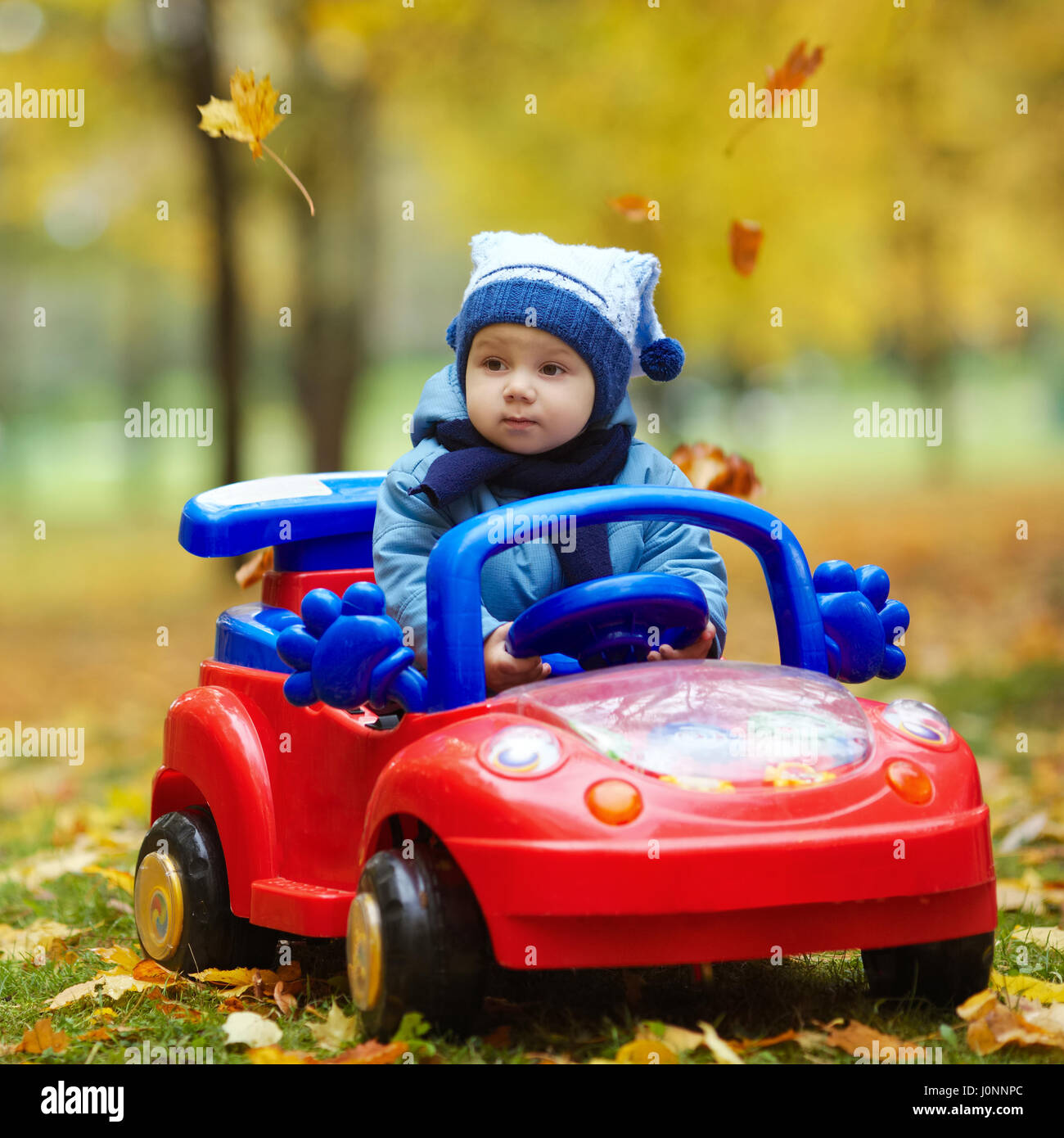 small boy driving car