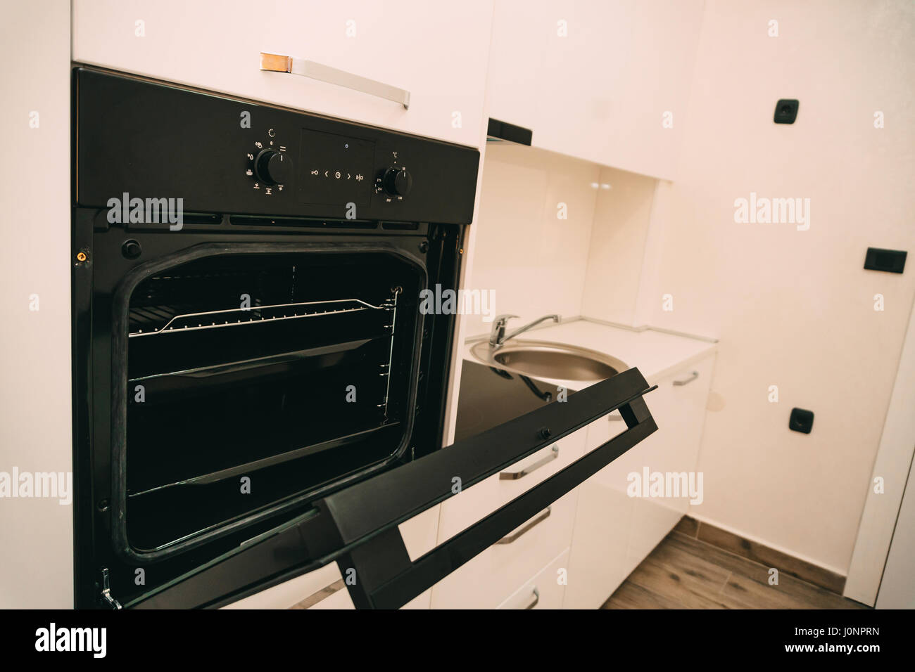The oven in the kitchen. Stove with oven. The kitchen in the apartment