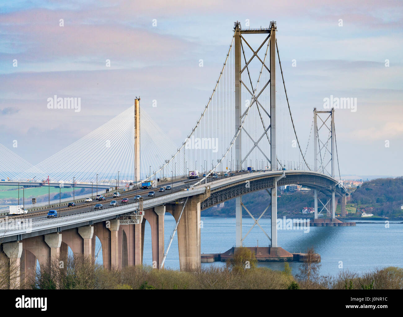 View of Forth Road Bridge and new Queensferry Bridge in distance under construction from South Queensferry, Scotland, United Kingdom Stock Photo