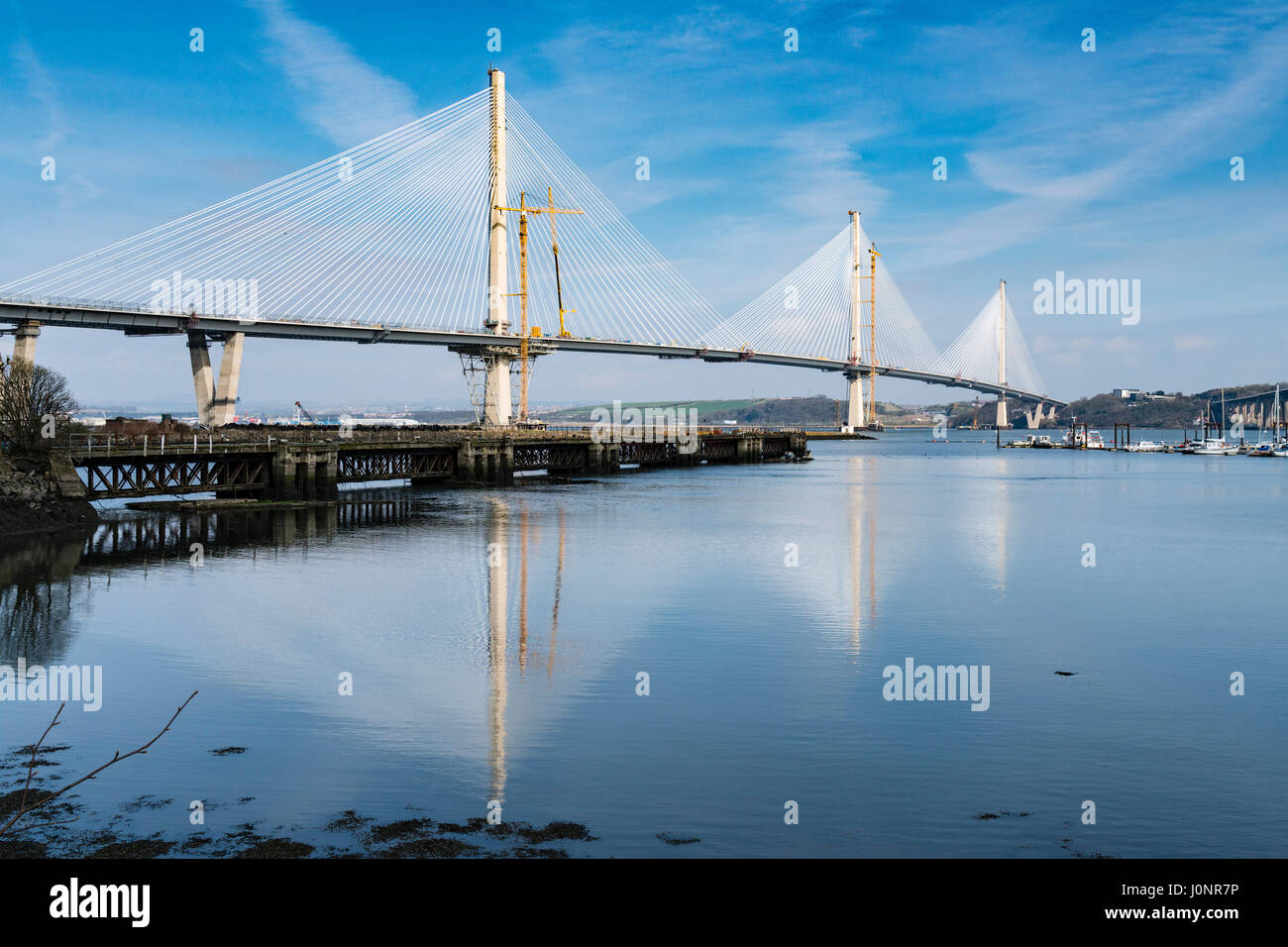 View of new Queensferry Crossing bridge under construction spanning River Forth from South Queensferry in Scotland, United Kingdom. Stock Photo