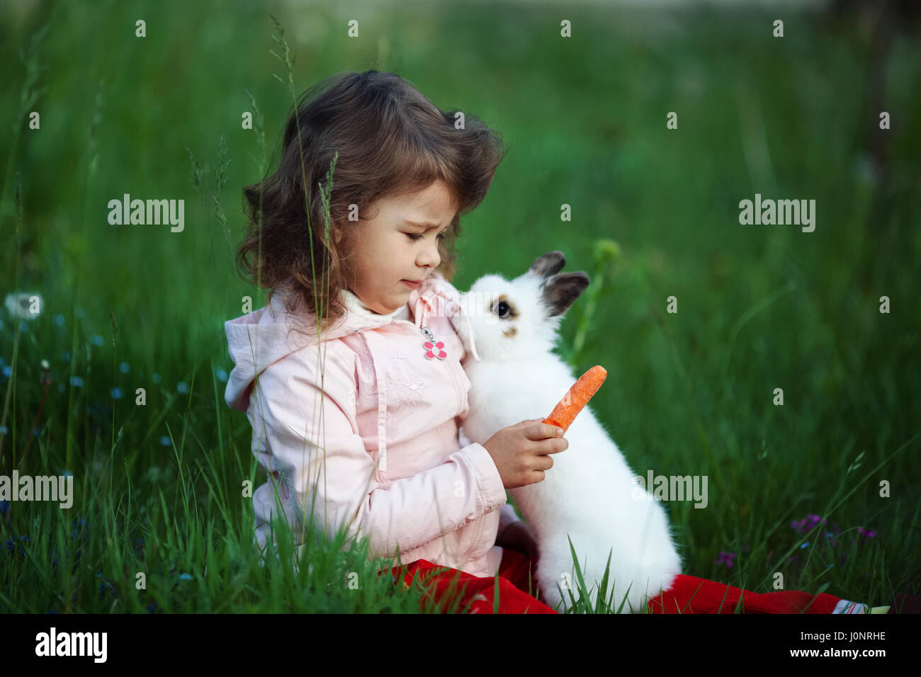 Children playing with pet rabbit hi-res stock photography and images ...