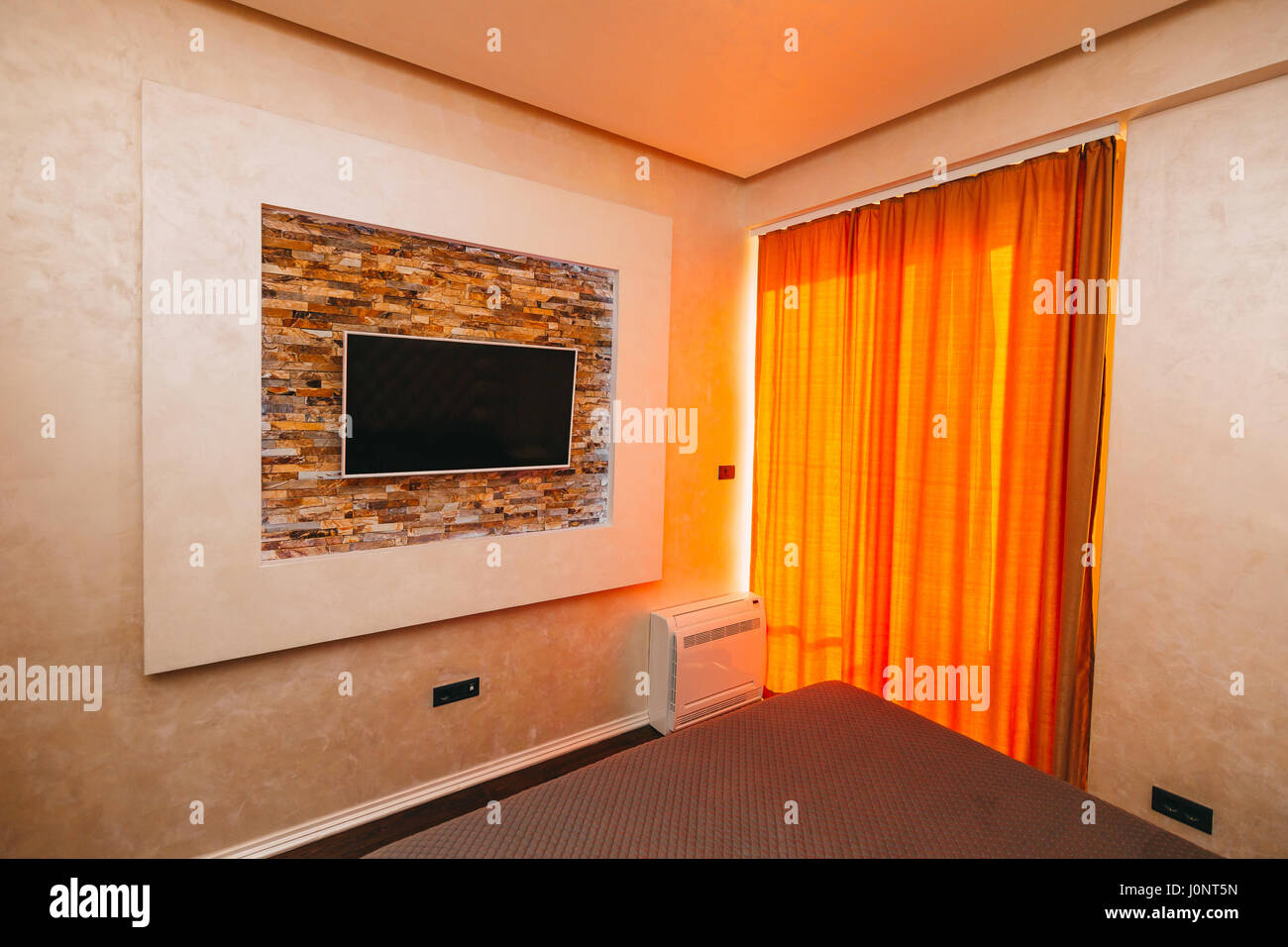 TV on the wall. TV hanging on the wall in the apartment Stock Photo Alamy
