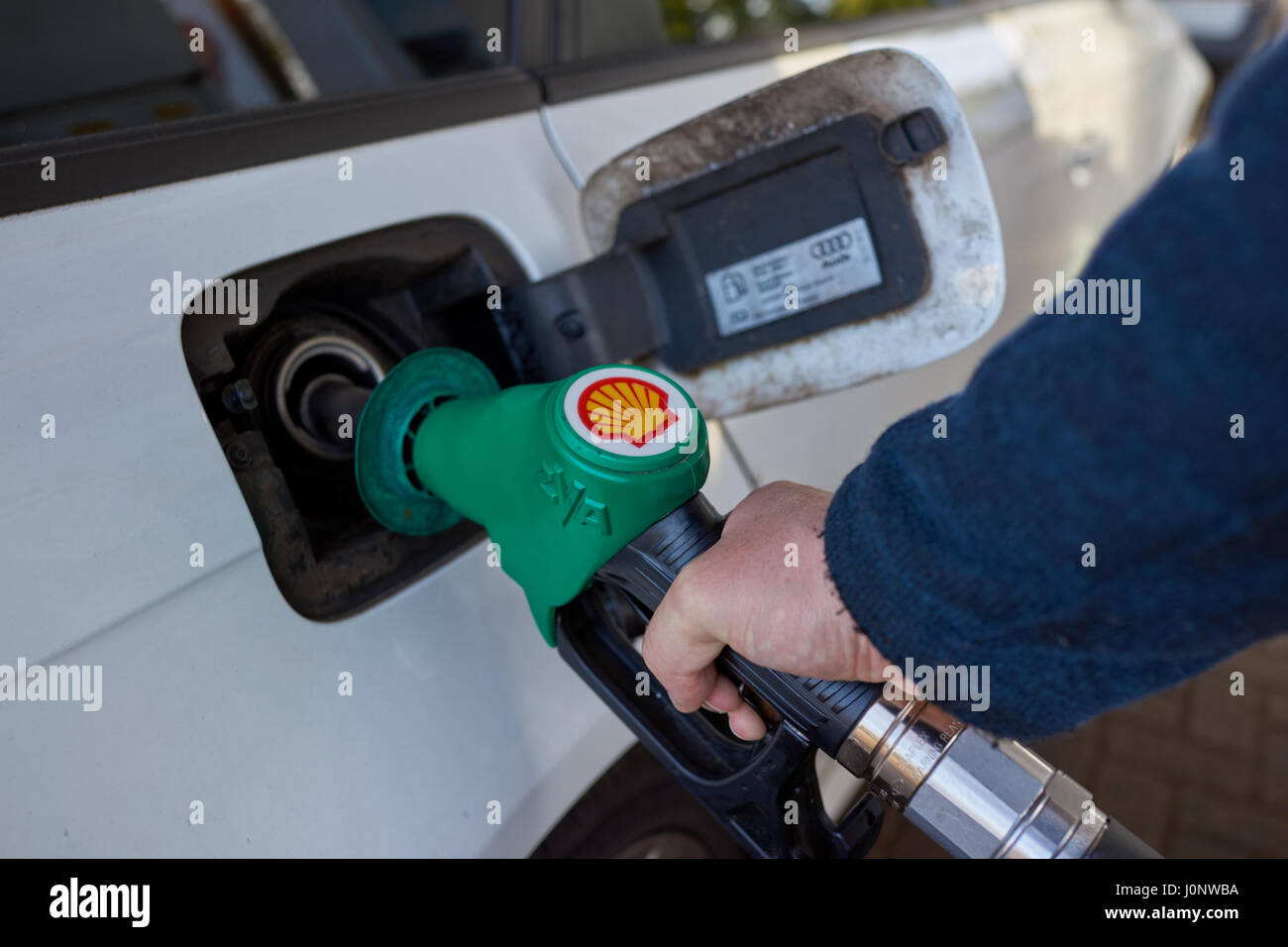 Filling up car with unleaded petrol at shell service station. Stock Photo