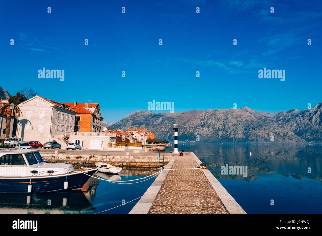 Black and white lighthouse in the sea. Prcanj, Kotor Bay, Montenegro