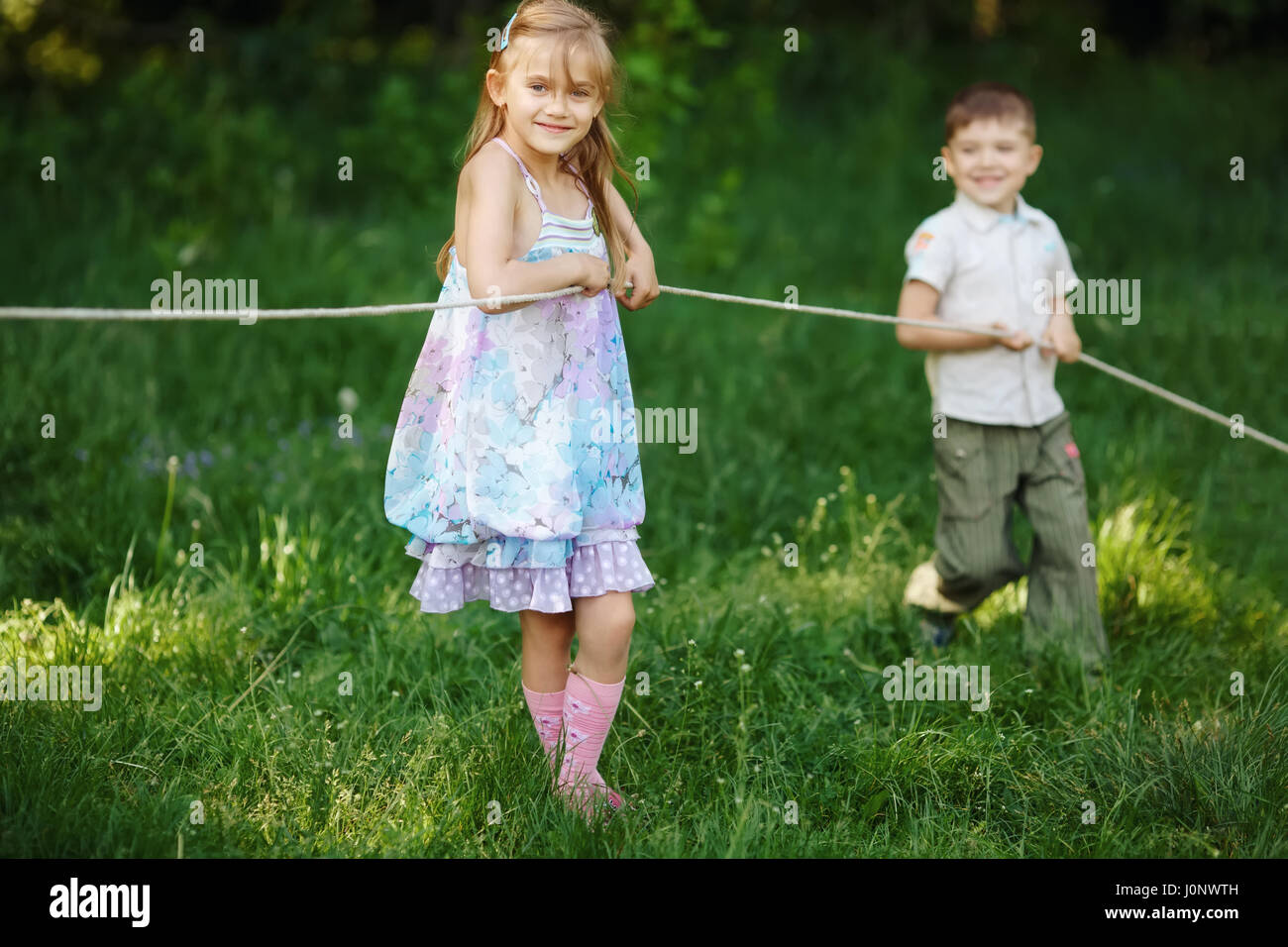 children pulling the rope outdoors Stock Photo - Alamy