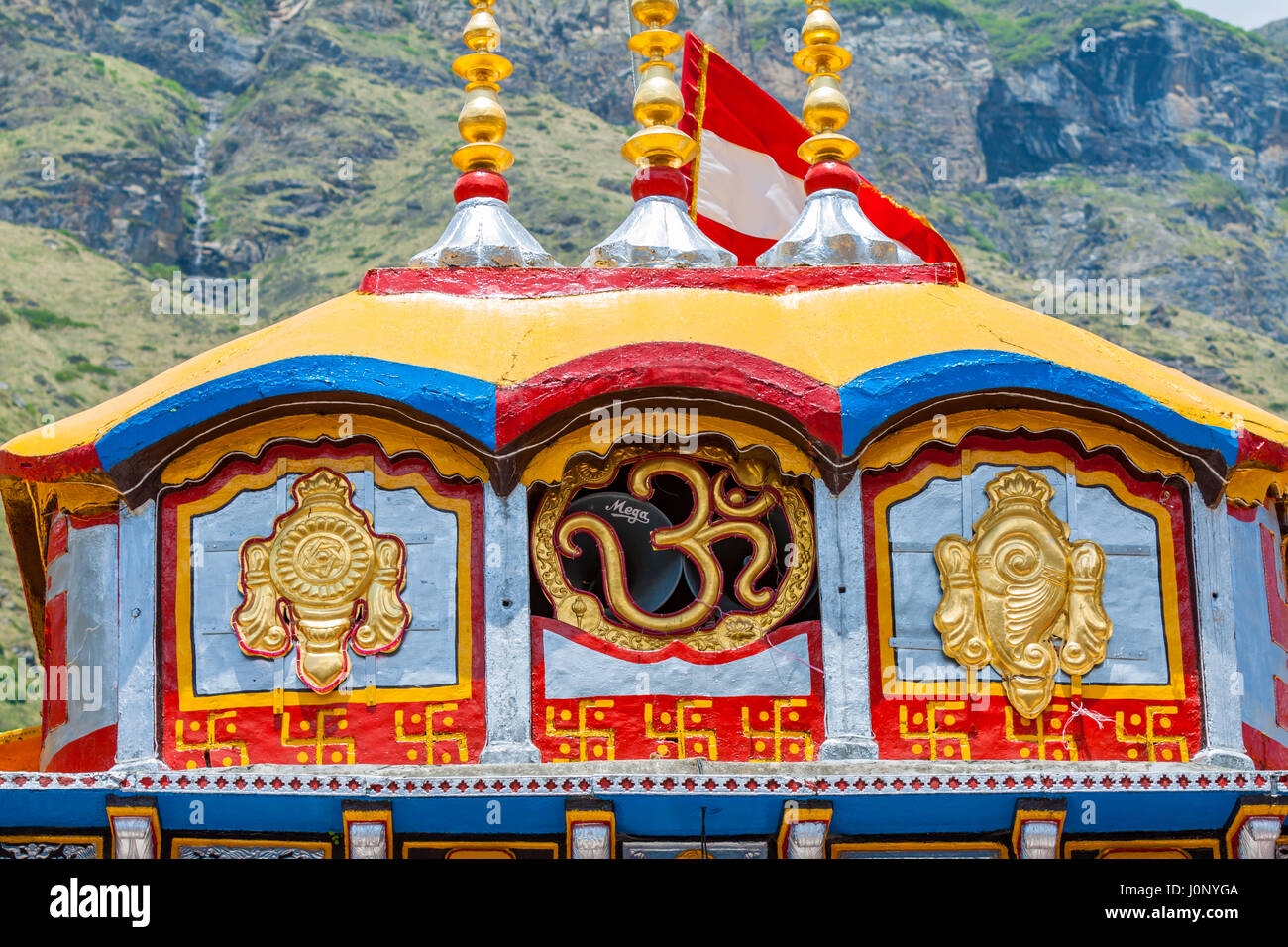The dome above the Badrinath Temple in Uttarkhand, North India, displaying the symbol om and the emblems of the Hindu God Vishnu. Stock Photo