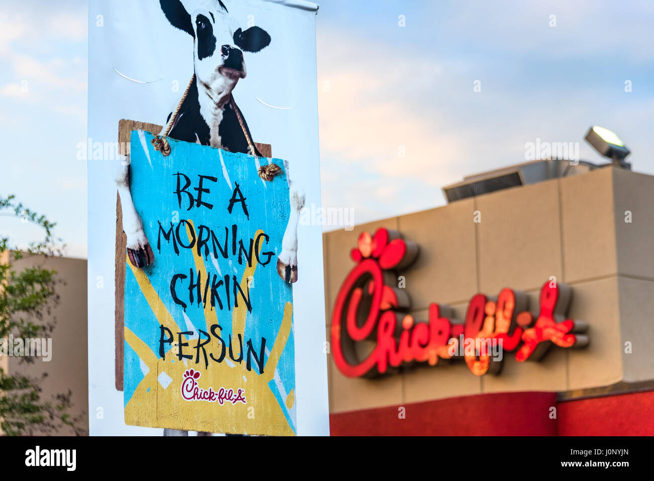 Chick-fil-A in Metro Atlanta with outdoor banner featuring graphics from the iconic Cowz campaign developed by the Richards Group adverting agency. Stock Photo