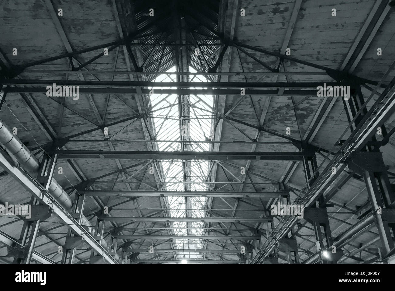 metal roof interiors structure of an old industrial building Stock Photo