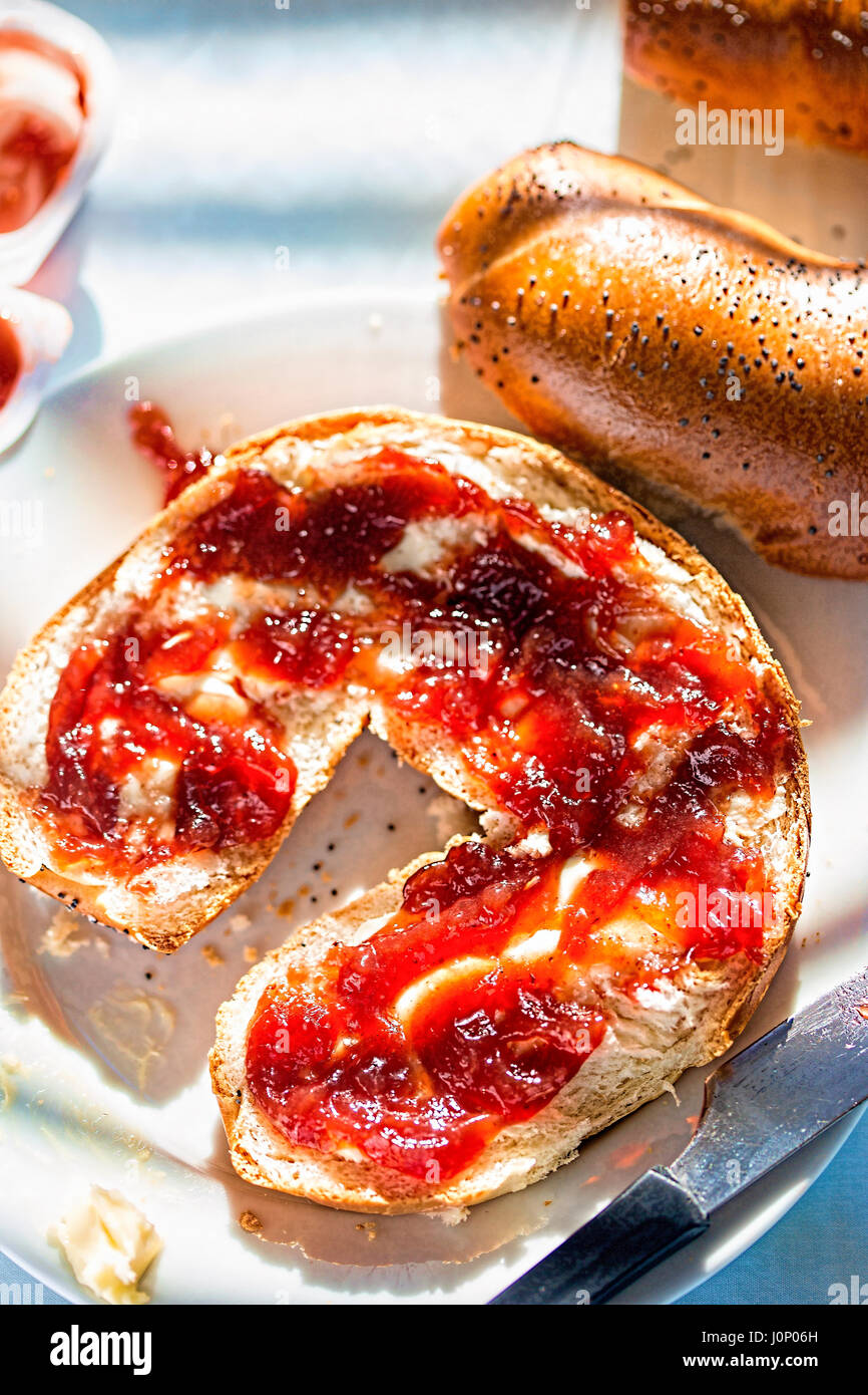 Poppy seed croissant with strawberry jam Stock Photo Alamy