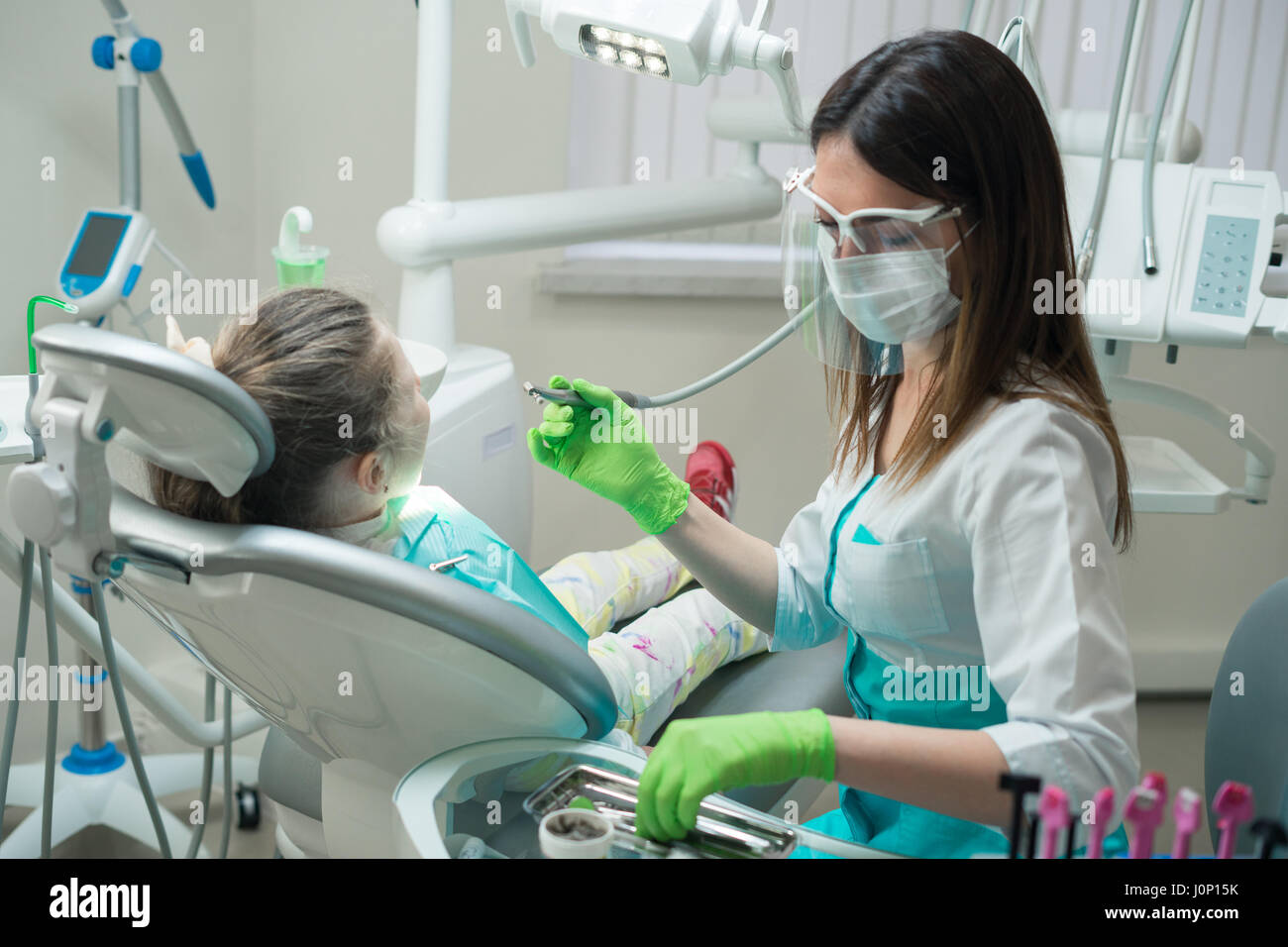 Female Dentist checking little girl patient Stock Photo