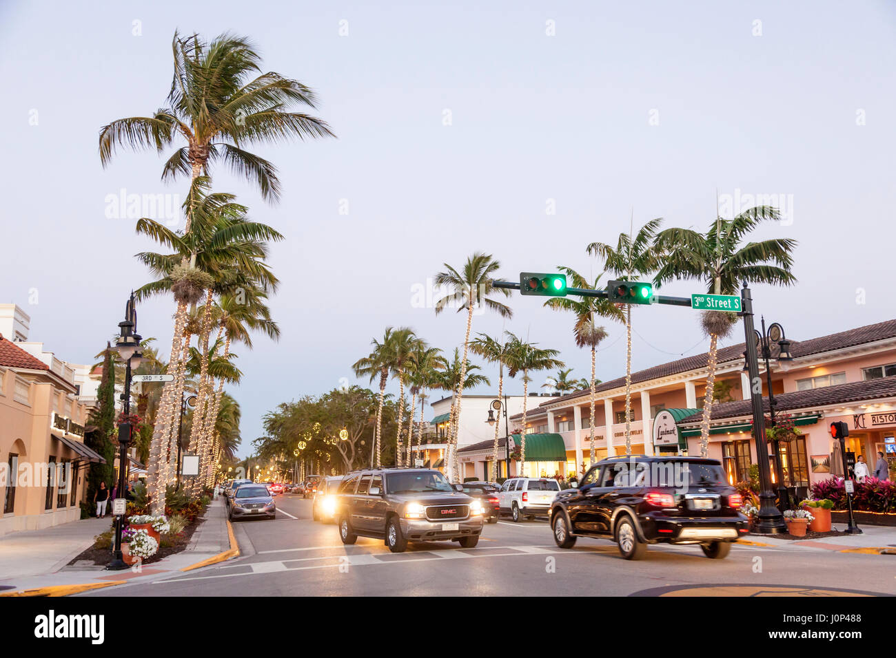 Naples, Fl, USA - March 21, 2017: Street with illuminated palm trees in the city of Naples. Florida, United States Stock Photo