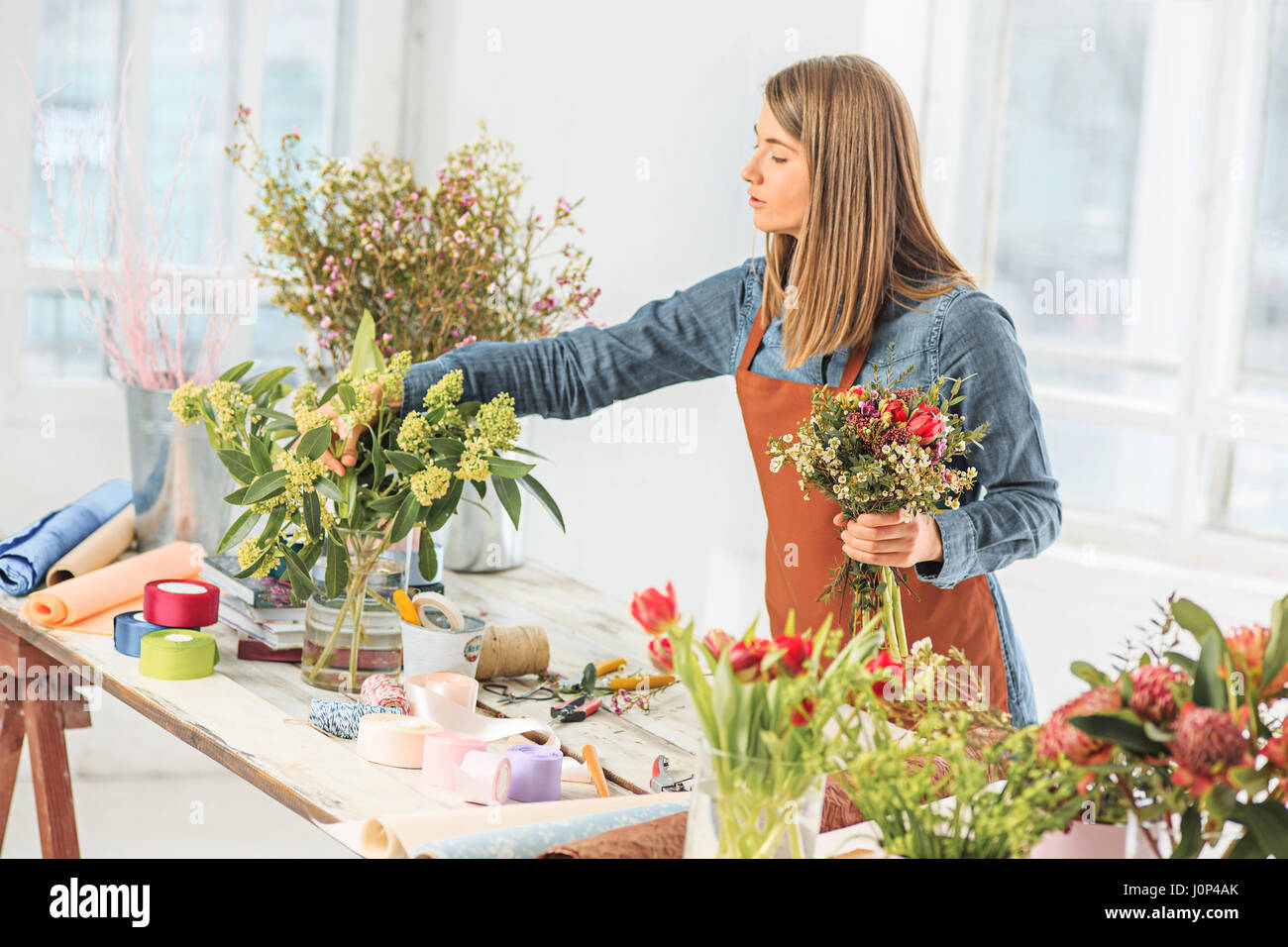 Florist at work: the young girl making fashion modern bouquet of ...