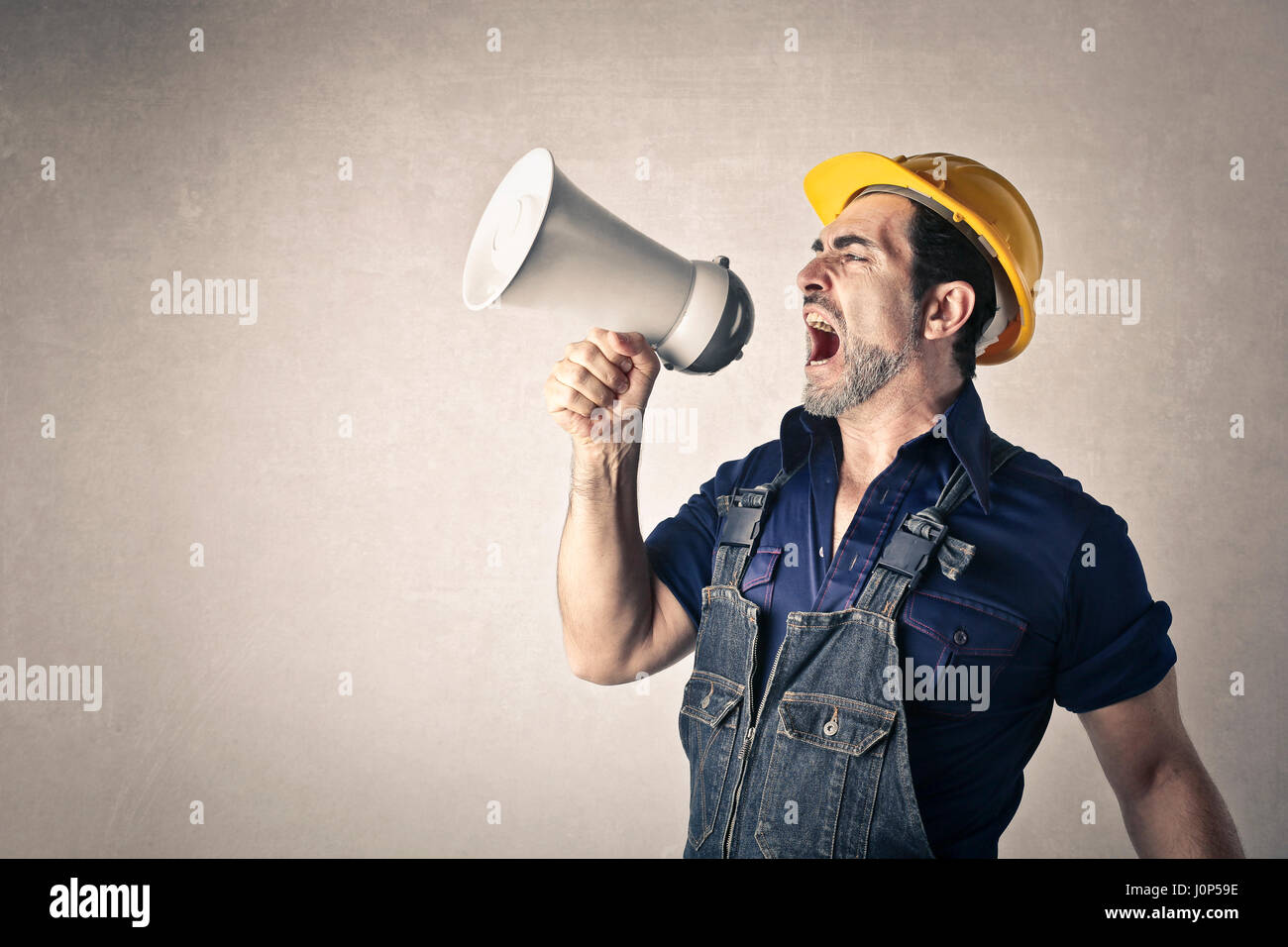 Construction worker with megaphone Stock Photo