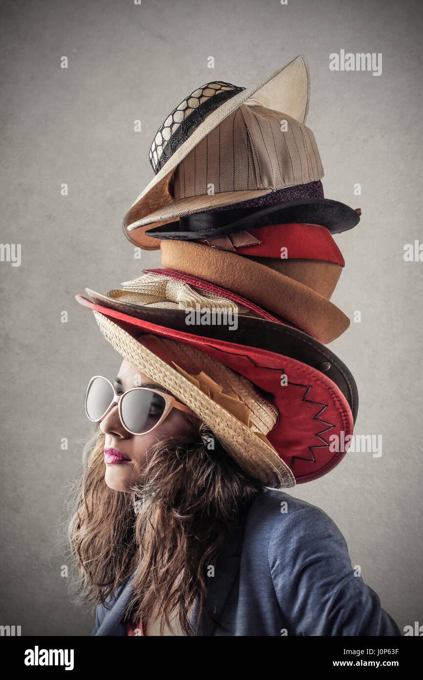 Woman wearing lot of hats Stock Photo - Alamy