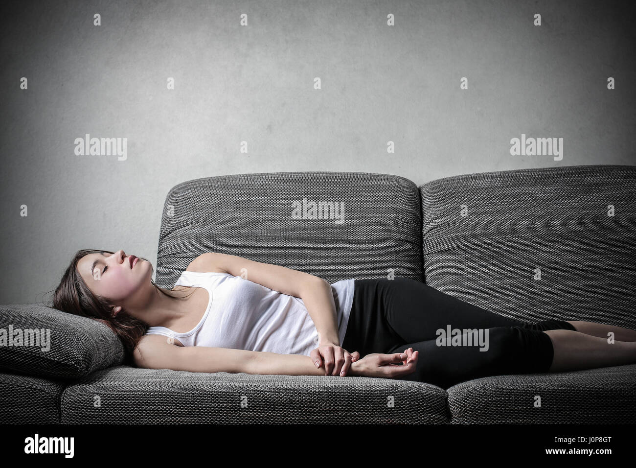 Teen girl laying on sofa hi-res stock photography and images - Alamy