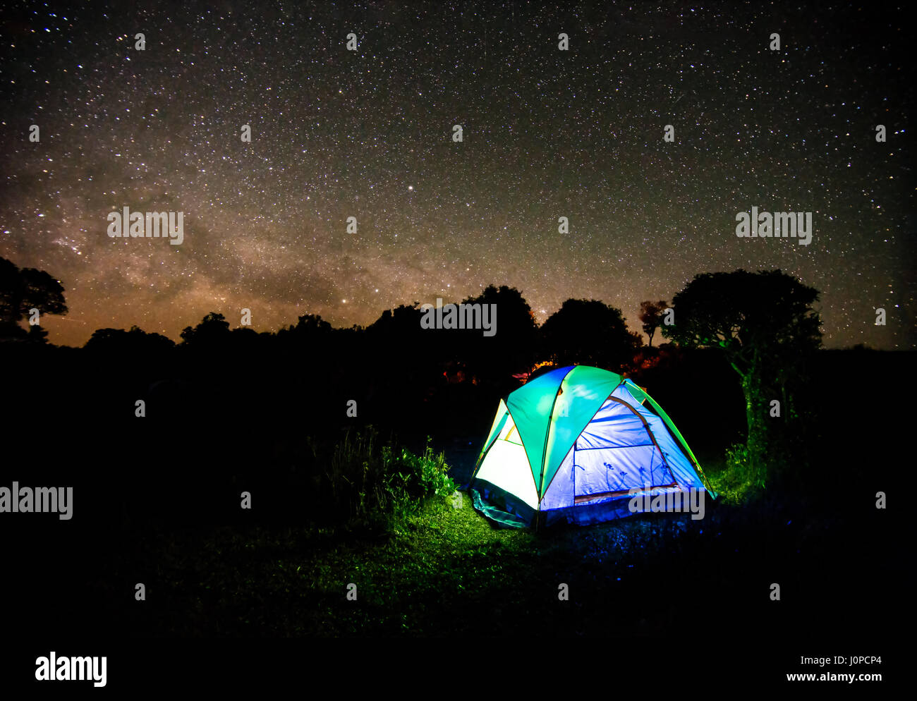 Camping tent under night sky stars with milky way background Stock