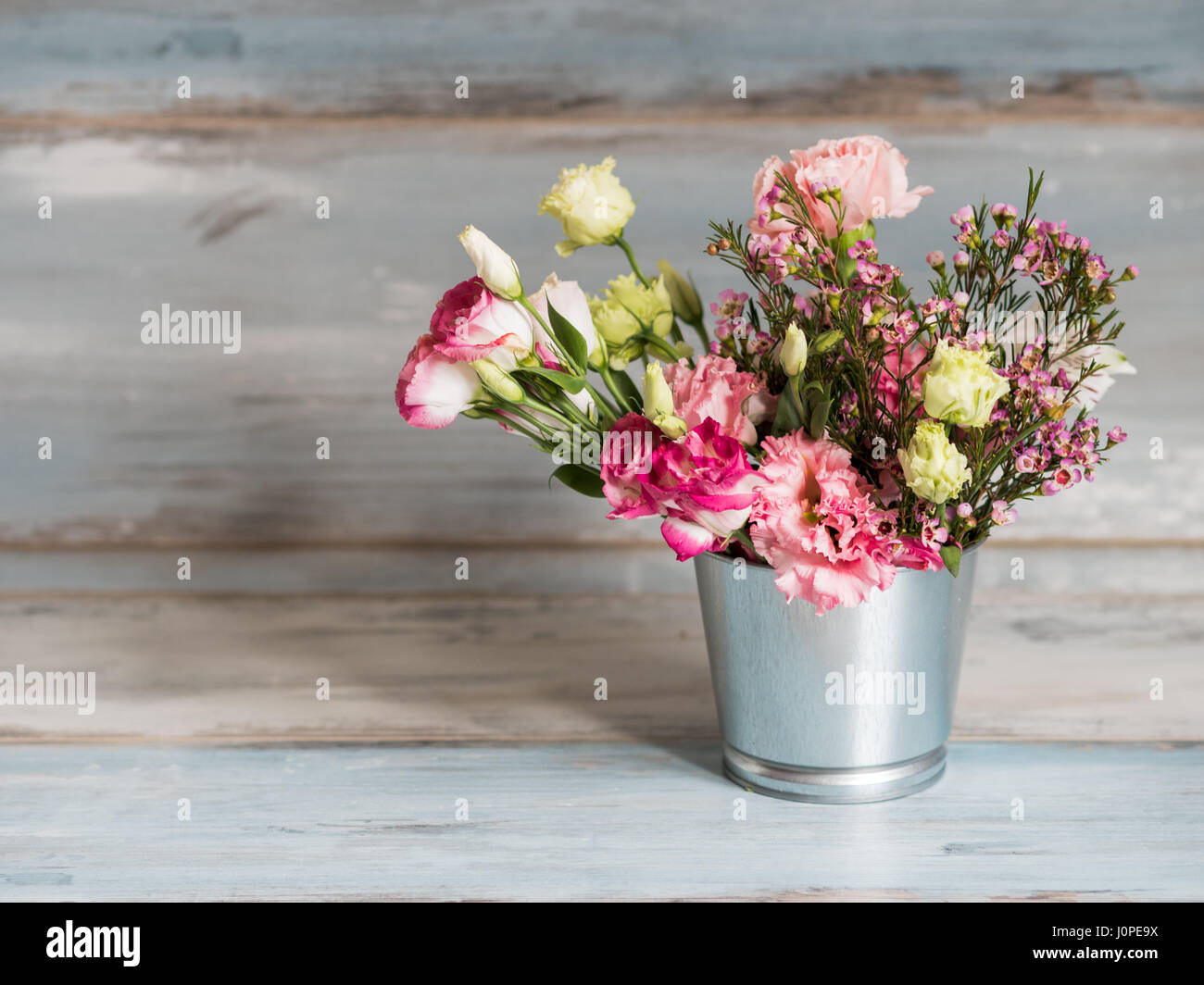 Spring flowers in small tin bucket Stock Photo Alamy