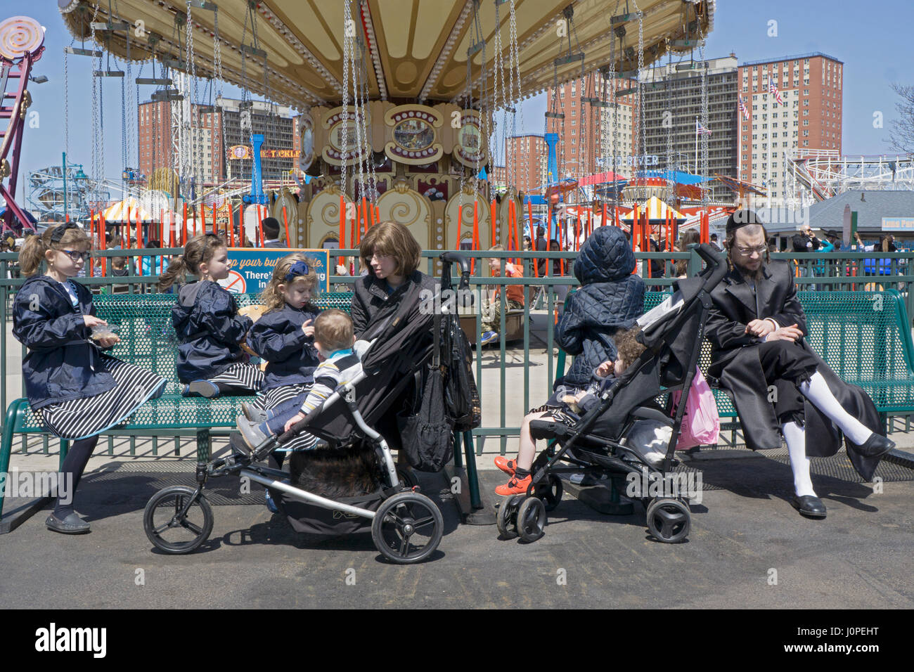 A religious Jewish family having fun during Passover at Luna Park in Coney Island, Brooklyn,, New York City. Stock Photo