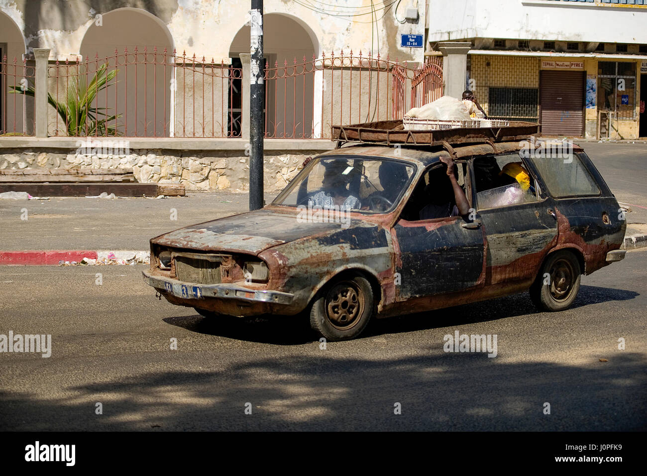 Old wreck of a car in use in Senegal Stock Photo Alamy